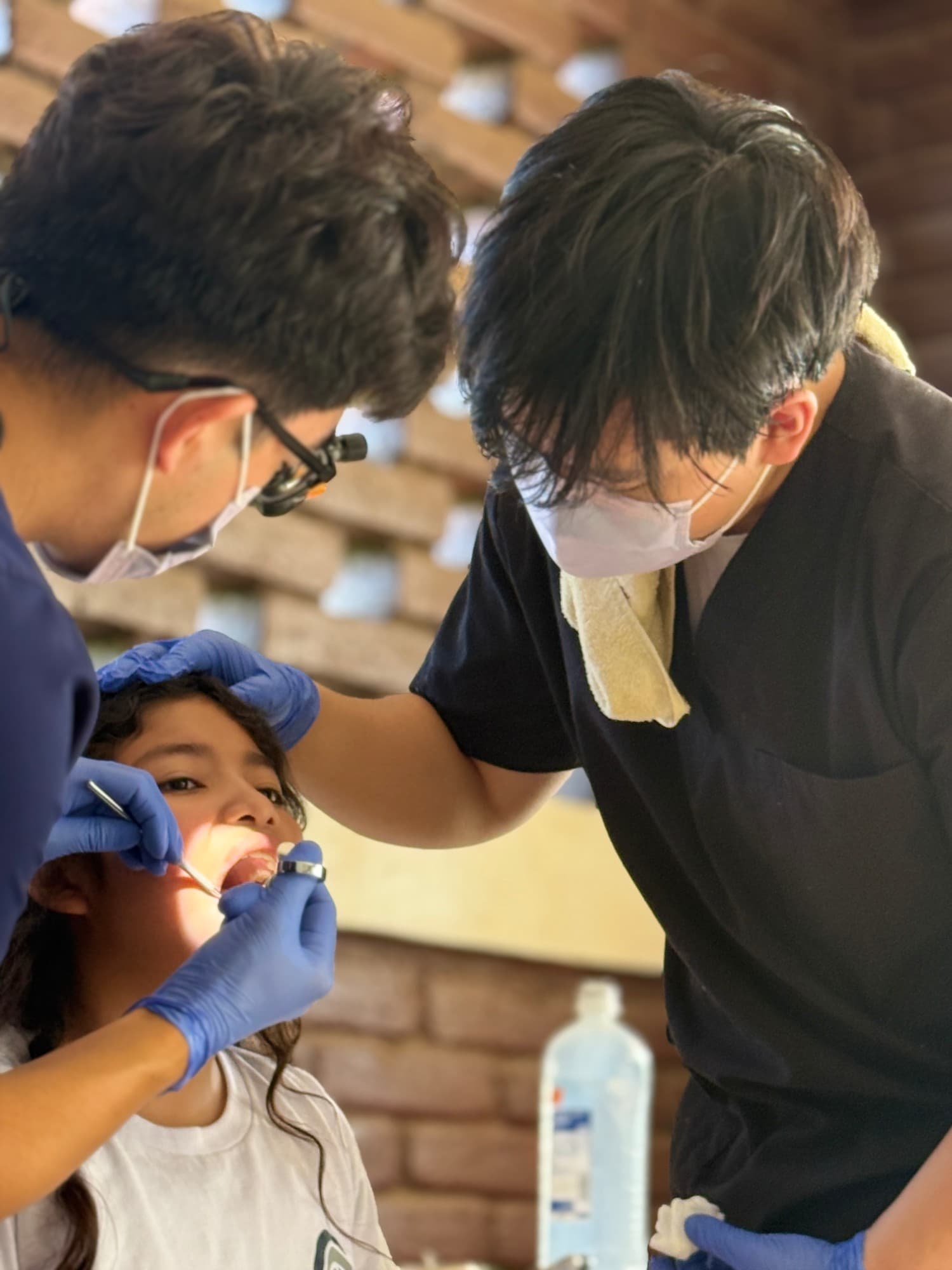 Volunteers examining a young patient's teeth during the Nicaragua dental mission